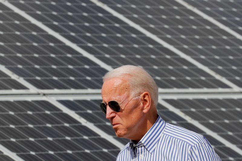 FILE PHOTO: Democratic 2020 U.S. presidential candidate and former Vice President Joe Biden walks past solar panels while touring the Plymouth Area Renewable Energy Initiative in Plymouth, New Hampshire, U.S., June 4, 2019.   REUTERS/Brian Snyder