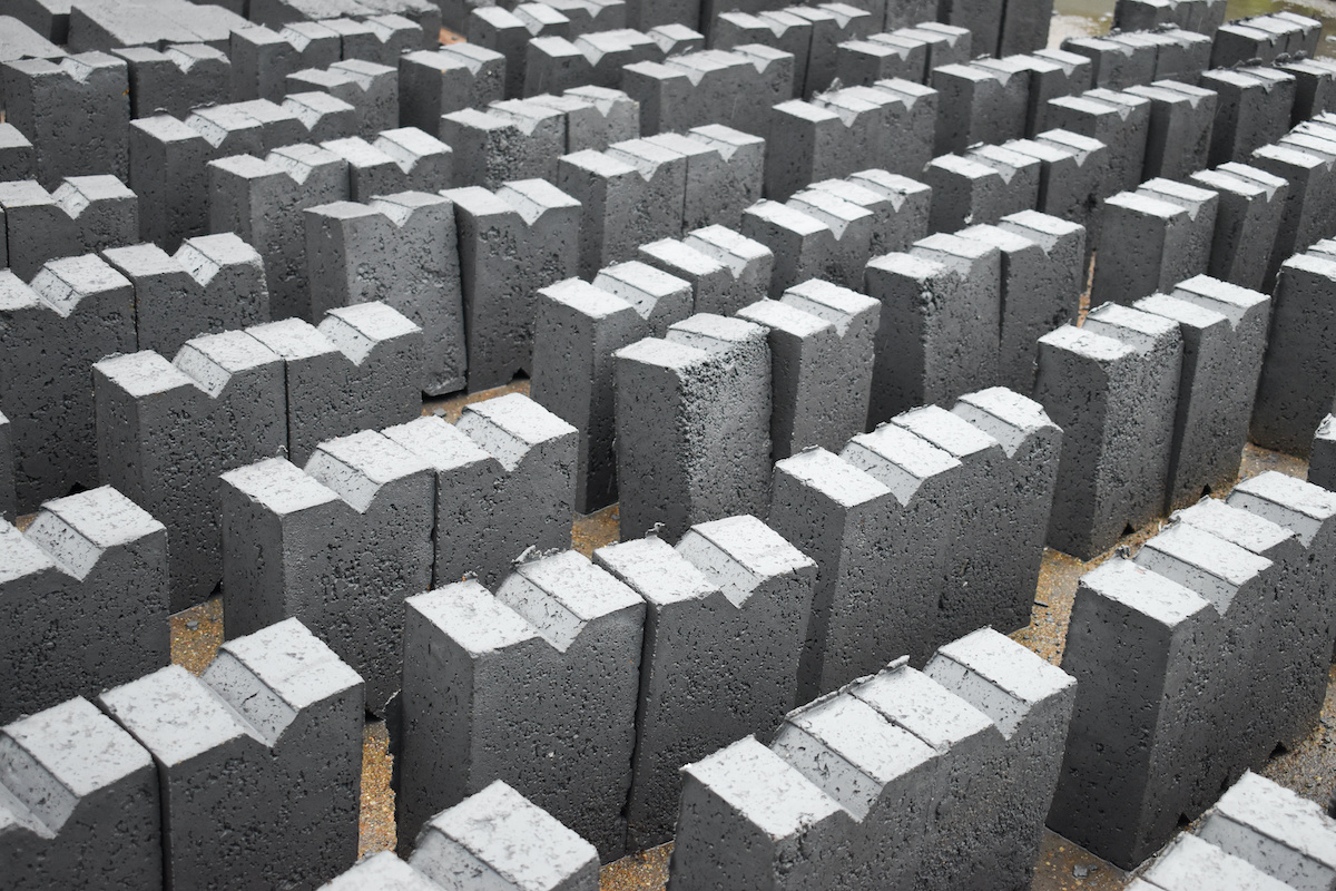 Full frame of fly ash bricks drying in sun heat